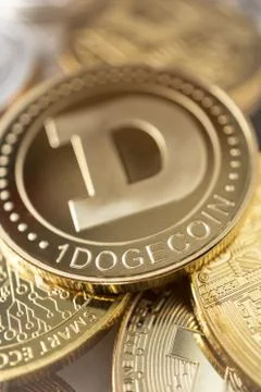 Close-up of dogecoin physical coin on stack of many other cryptocurrencies Stock Photos