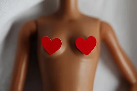 Close-up of doll body with two red hearts on breast. Relationship concept. Stock-Fotos