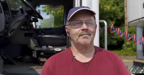 Close up dolly around driver standing by side of truck 4K Stock Footage 79865740