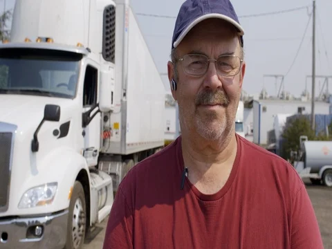 Close up dolly around driver standing in front of truck 4K Stockbeeldmateriaal 79866341