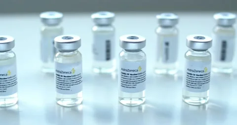 Close up dolly of AstraZeneca Covid-19 vaccine vials bottles with a heath worker Stock Footage