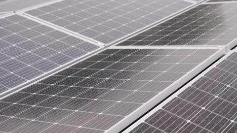 Close up dolly forward tracking shot over solar panels while raining. Stock Footage 155375196