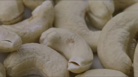 Close up dolly left shot of portion of raw cashew nuts, one rotten on pile Stock Footage 280261937