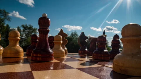 Close-up dolly macro shot of a white wooden chess queen on a chessboard. Smooth Stock Footage 205518980