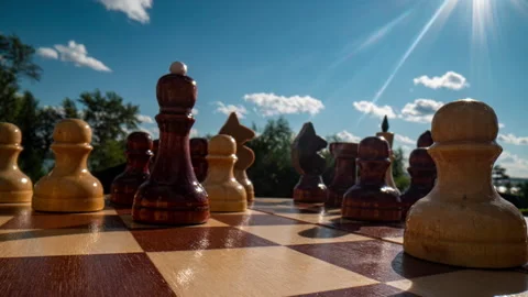 Close-up dolly macro shot of a white wooden chess queen on a chessboard. Smooth Stock Footage 208957376