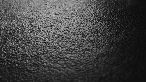 A close-up dolly panorama of a black and white surface Stock Footage 254131337