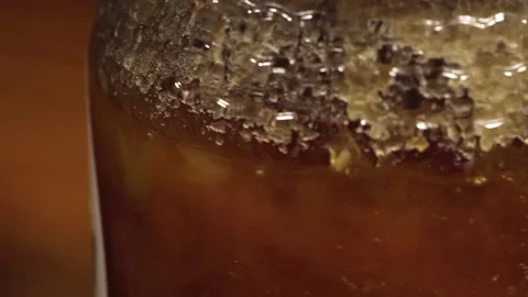 Close up dolly past bottle of crystallized honey Stock Footage 156454825