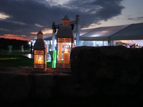 Close up dolly shot of decorated lanterns and large party tent in background Video stock 72546339