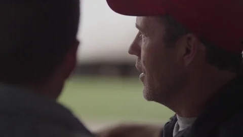 Close-up dolly shot of farmers talking in barn Stock Footage