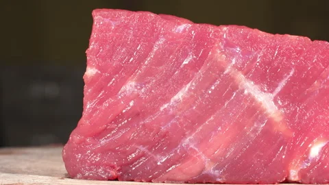 Close-Up Dolly Shot of Fresh Raw Beef Steak on Board Stock Footage 343250316