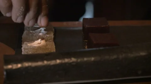 A close up dolly shot of a hand applying sprinkles to a dessert Stock Footage 58770732