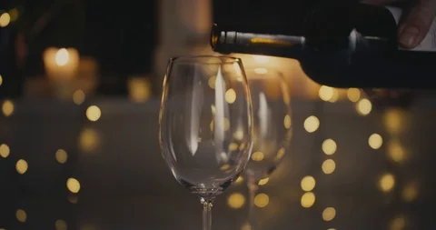 Close-up dolly shot. Two glasses are filled with red wine. The glasses are Stock Footage 100875251