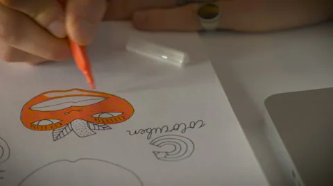Close up dolly shot of a young man creating comic by hand Stock Footage 52271760
