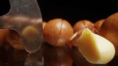 Close Up Dolly Slider Shot of Macadamia Nuts Scattered with Open Shells and Spec Stock Footage 324561475