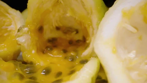 Close Up Dolly Slider View of Empty Passion Fruit Shells With Remaining Yellow Stock Footage 314410752