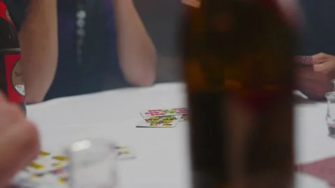 Close dolly tracking shot of a group of men playing a tyrolean card game Stock Footage 221031478