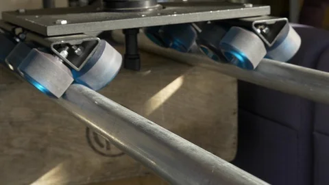 Close up of a dolly with a video camera mounted to it moves on trackst. Stock Footage 99426628