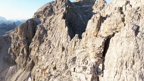 Close-up of Dolomites' textured cliffs, showcasing sunlit stratified rock Video stock 253544845
