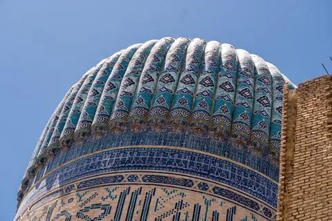 Close up on the dome of Bibi-Khanym Mosque in Samarkand, Uzbekistan. Blue s.. Stock Photos