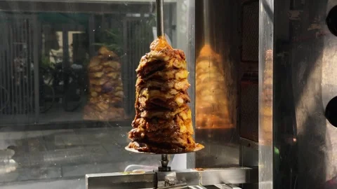 Close Up of Doner Kebab Meat Cone rotating on Rotisserie Spit in Street Stock Footage 341542590