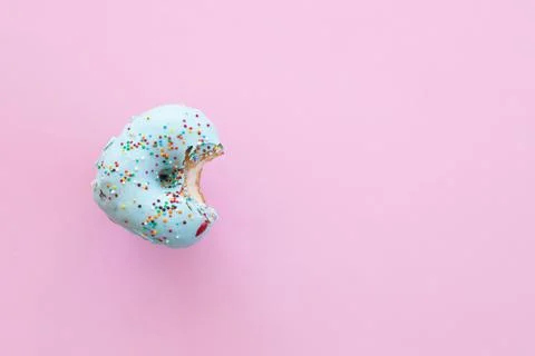 Close up donut with bite missing isolated on white background Foto stock