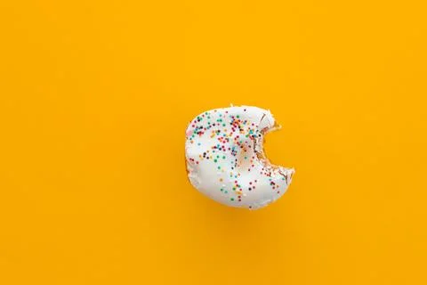 Close up donut with bite missing isolated on color background Stock Photos
