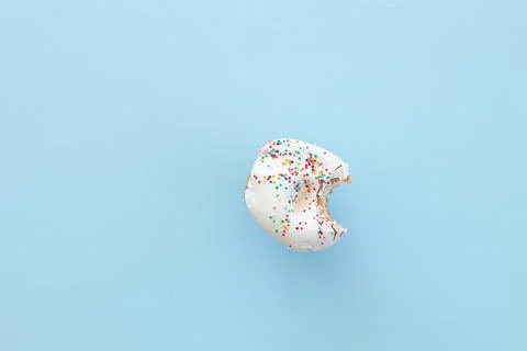 Close up donut with bite missing isolated on color background Stock Photos