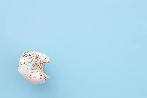 Close up donut with bite missing isolated on color background Stock Photos