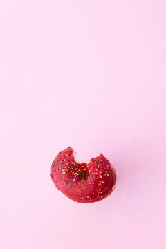 Close up donut with bite missing isolated on color background Stock Photos