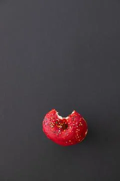 Close up donut with bite missing isolated on color background Foto stock