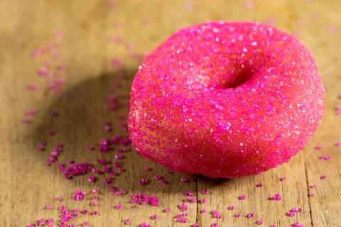 Close up of donut decorated with pink sugar sprinkles Stock Photos
