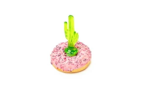 Close up donuts on a bright background. Creative concept junk food. toy cactu Stock Photos