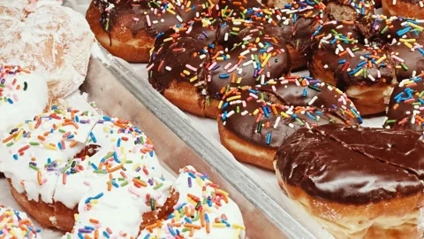 Close-up of Donuts with Chocolate and White Sprinkles Stock Footage 304306013