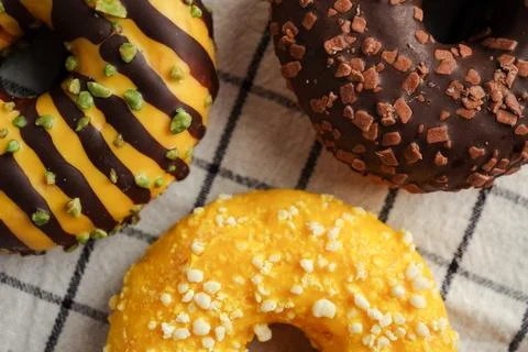 Close up of donuts texture with glaze and toppings Photos