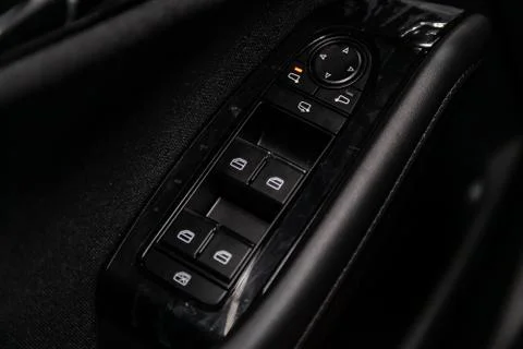 Close up of a door control panel in a new modern car. Arm rest with window co Stock-Fotos