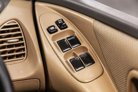 Close up of a door control panel in a new modern car. Arm rest with window co Stock Photos