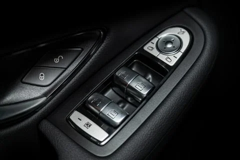 Close up of a door control panel in a new modern car. Arm rest with window co Stock-Fotos