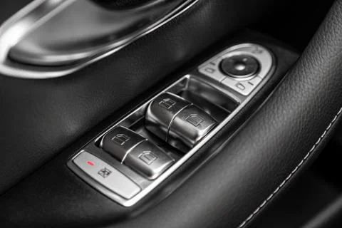 Close up of a door control panel in a new modern car. Arm rest with window co Stock-Fotos