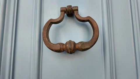 Close-up of a door knocker mounted on a blue wooden door Stock-Footage 317177057