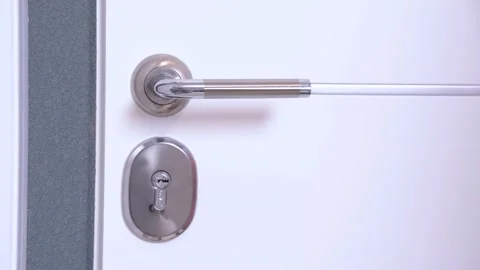 Close up door lock and human hand opening it into the darkness. Stock Footage