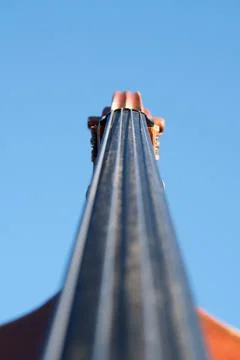 Close-up of Double Bass Neck with Selective Focus on Blue Sky Background Stock Photos