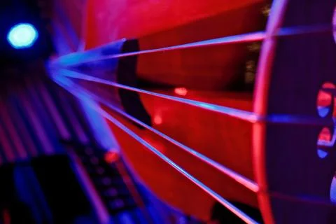 Close-Up of Double Bass Strings with Red and Blue Dramatic Lighting Foto stock