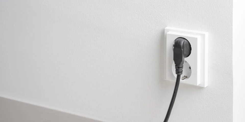 A close-up of a double electrical outlet mounted on a white wall Foto stock