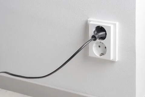 A close-up of a double electrical outlet mounted on a white wall, with a po.. Foto stock