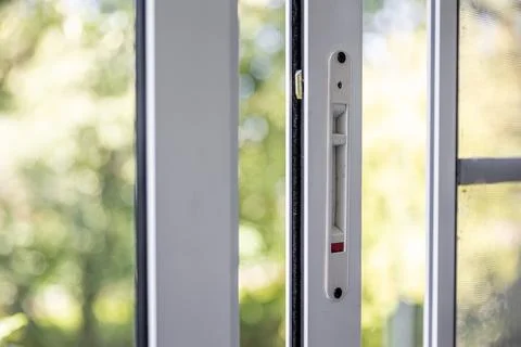 Close-up of a double-glazed balcony frame with a latch and fastening for safe Stock Photos