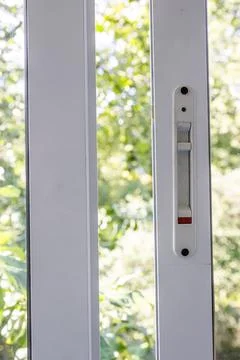 Close-up of a double-glazed balcony frame with a latch and fastening for safe Stock Photos