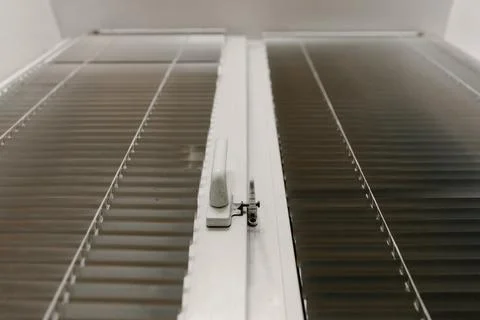 Close-up of double-glazed plastic window frame, one-way kitchen window handle Stock Photos