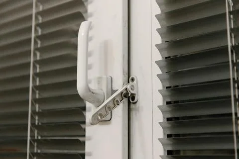 Close-up of double-glazed plastic window frame, one-way kitchen window handle Stock Photos
