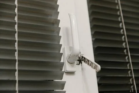 Close-up of double-glazed plastic window frame, one-way kitchen window handle Stock Photos