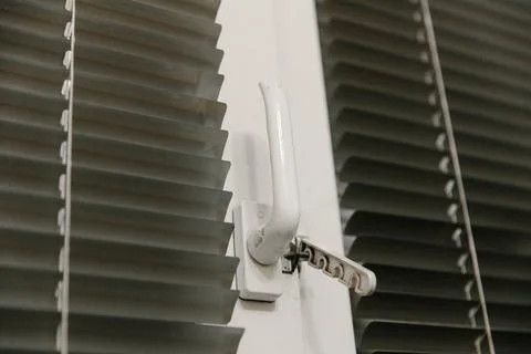 Close-up of double-glazed plastic window frame, one-way kitchen window handle Stock Photos
